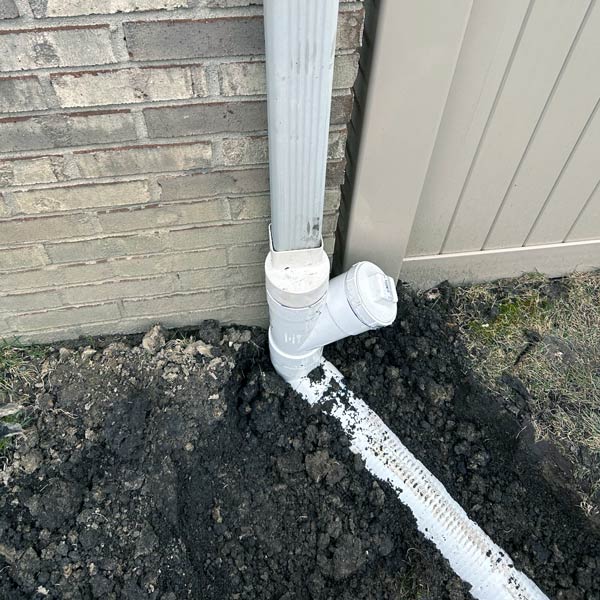 New underground downspout extension piping before buried